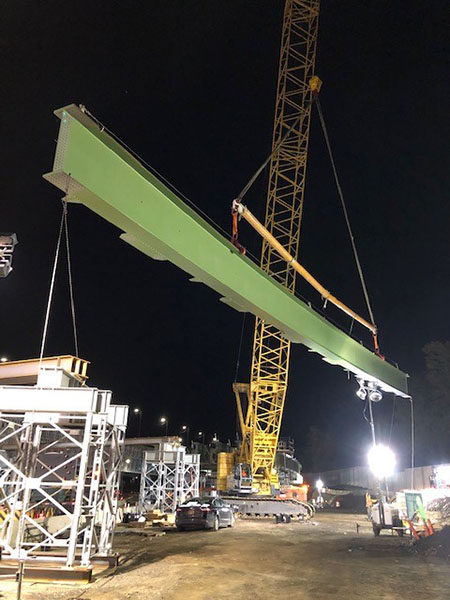 Kobelco CK2500-II crawler crane hoists a new curved steel bridge girder into place.